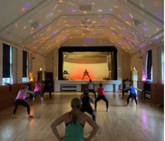 Image of people in the hall exercising to music.