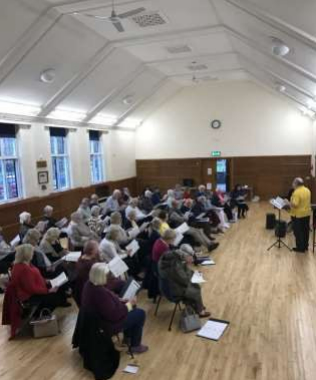 Group attending a singing lesson.